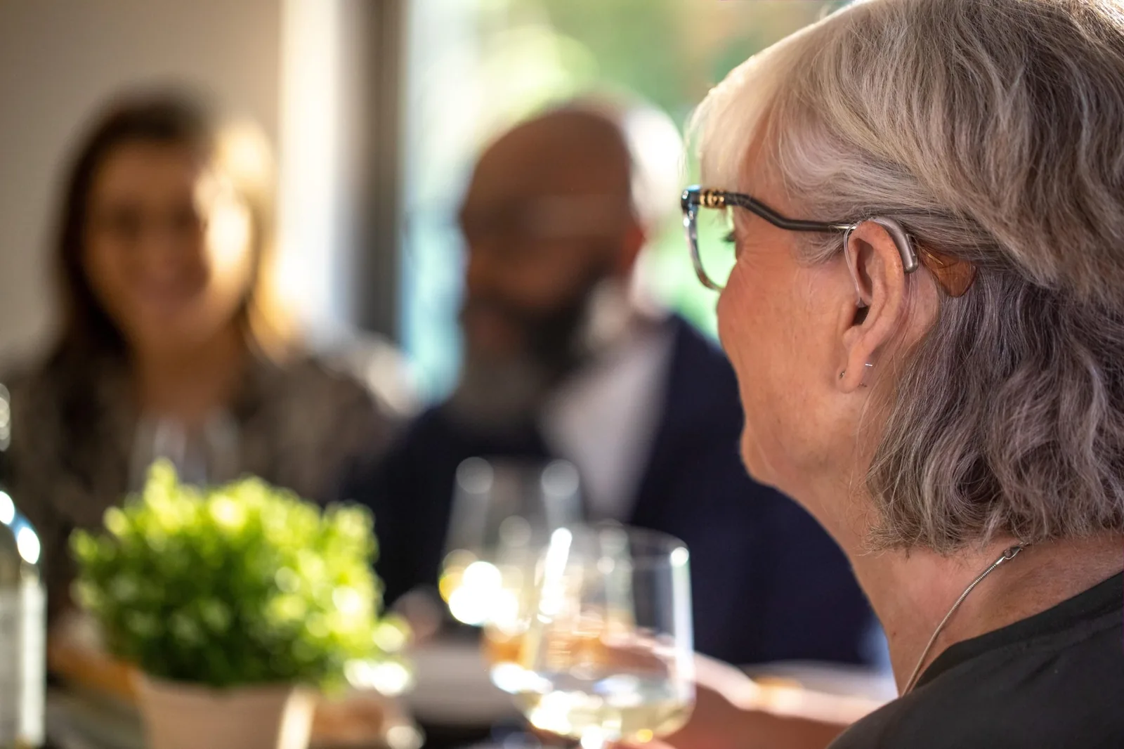 Modern discreet hearing aid being worn