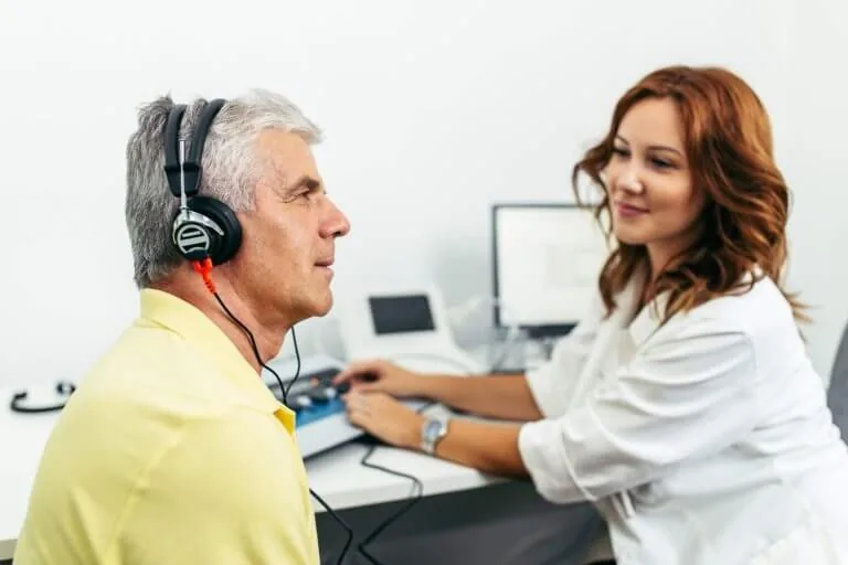 Audiologist performing a hearing assessment with headphones